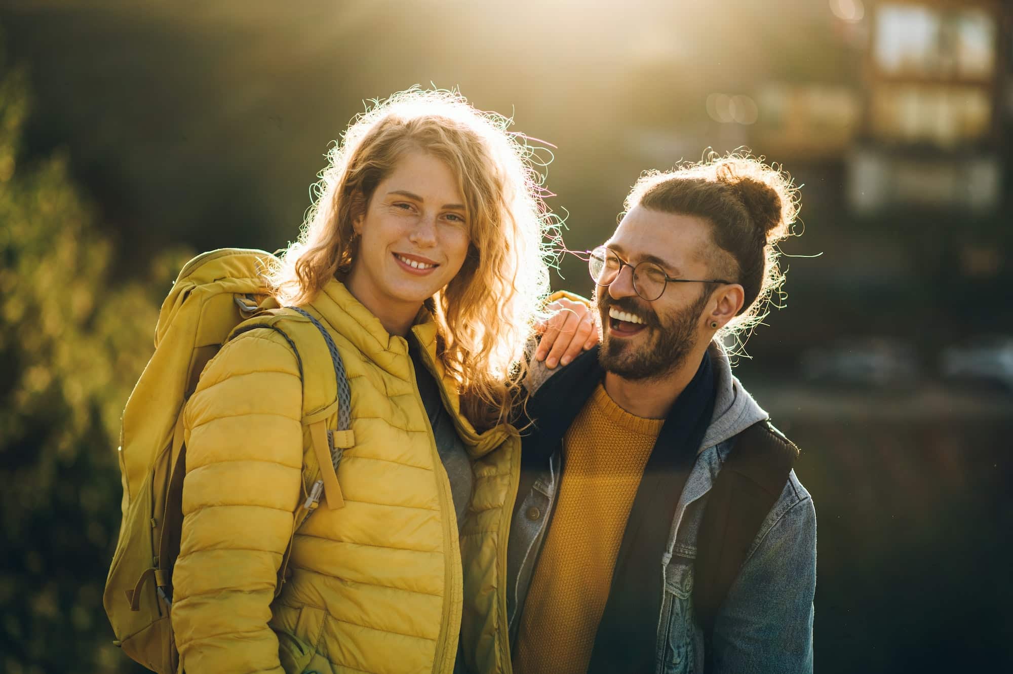 Portrait of a smiling couple of hikers walking on a mountain trail during a vacation